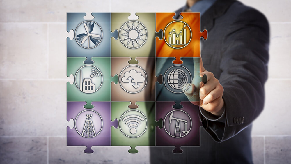 Blue chip plant manager touching chart icon in virtual planning matrix in form of a jigsaw puzzle. Industry concept for smart energy management, real time data, energy efficiency, energy monitoring.