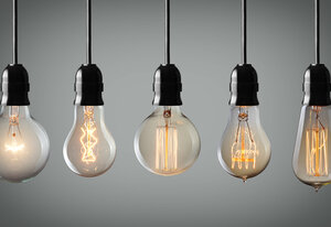 Vintage hanging light bulbs over gray background 